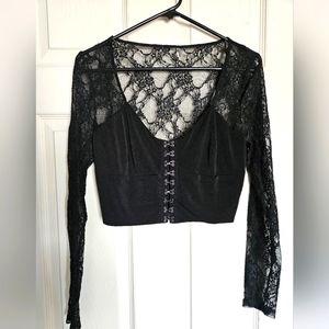 Cropped long sleeve black corset top. No brand name. No label or specific size.